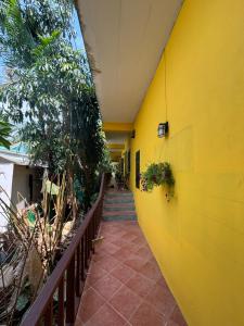 a yellow building with a yellow wall at Moondance Cottage Inn in Ko Chang