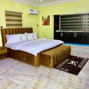 a bedroom with a large bed in a room at MOK Apartments & Suites in Lagos