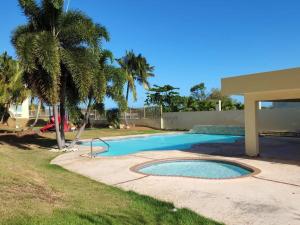 una piscina en un patio con una palmera en Kodesh Vacation Club Combate, Cabo Rojo, en El Combate