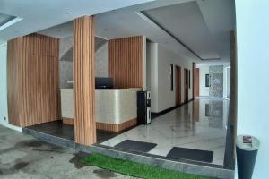 a hallway of a building with a lobby with a trashcan at Urbanview Hotel Nardis Living near UMY in Ngabean