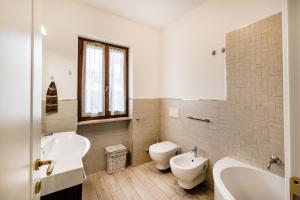 a bathroom with two sinks and a tub and a toilet at Casa al Ponte dei Marmi - few KM to sea - Happy Rentals in Seravezza