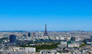 a view of a city with the eiffel tower at Full apt - Top floor - Eiffel Tower Panoramic View in Issy-les-Moulineaux +24 photos