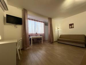 um quarto com uma cama, uma secretária e uma janela em Cefalù Suite em Cefalù