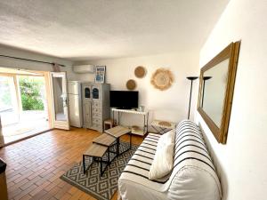 ein Wohnzimmer mit einem weißen Sofa und einem Tisch in der Unterkunft Loucasa in Roquebrune-sur-Argens