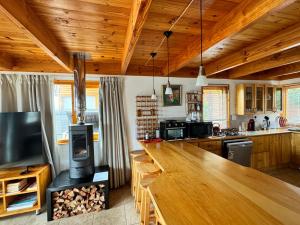 a kitchen with a large wooden counter and a stove at Pirates Creek no 9 in Wilderness