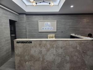 an office with a reception desk and a sign at H-Evian Hotel in Gwangju
