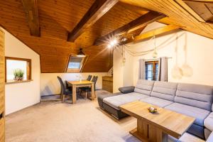 a living room with a couch and a table at Pension Hubert in Raspenava