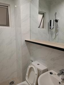 a white bathroom with a toilet and a sink at Bayu Temiang Luxury Design 7~8 Pax in Seremban