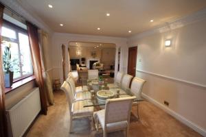 a dining room with a table and chairs at High Gable House -Four Bedrooms in Hillingdon
