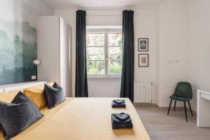 a bedroom with a large bed with a large window at La Casina 348 in Rome