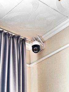 a security camera on a ceiling with a curtain at Гостиничный комплекс Bal-Meyir in Almaty