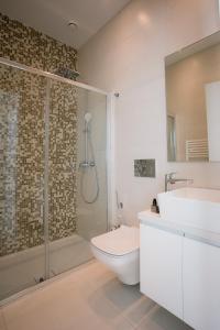a bathroom with a shower and a toilet and a sink at Sea Pearl Beachfront Villas - Breeze in Ayia Napa