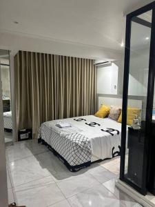 a bedroom with a bed and a large mirror at Your home in central Luanda in Luanda