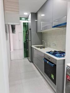a kitchen with a sink and a stove in it at Your home in central Luanda in Luanda