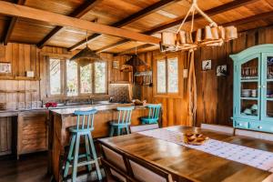 a kitchen with wooden walls and a wooden ceiling at Vila Vento in Atins