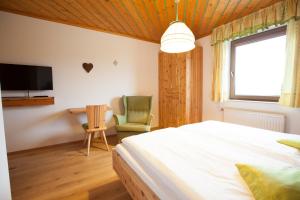 a bedroom with a bed and a desk and a chair at Gasthof Einfalt in Grossgerungs