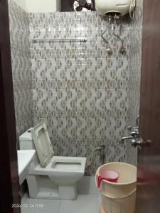 a bathroom with a toilet and a sink at Hotel Savera, agra in Agra