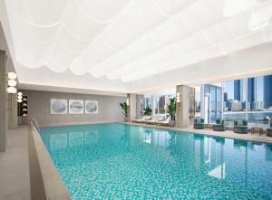 a large swimming pool in a building with a view at The Westin Josun Busan in Busan