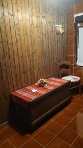 a bed in a room with a chair and a table at Il tempio nel bosco The Rustic Rooms & Wine 