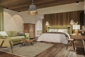 ein Schlafzimmer mit einem Bett, einem Sofa und einem Tisch in der Unterkunft Hotel Penzinghof in Oberndorf in Tirol