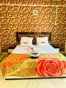 a bedroom with a bed with a flower on it at Divine palace in Vrindāvan