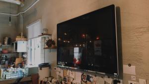 a large flat screen tv hanging on a wall at Amouter HC in Hengchun