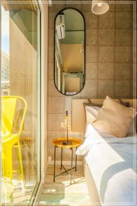 a bedroom with a bed and a mirror and a table at Dream Beach Hotel And Spa in Tel Aviv