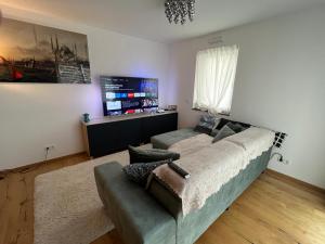 sala de estar con sofá y TV en Zentral & ruhig wohnen in Gießen, en Giessen