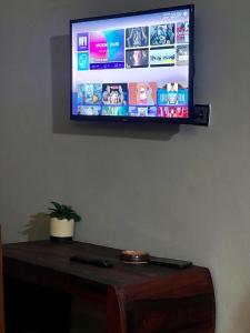 a flat screen tv hanging on a wall at Le Jardin Arhumatic in Sambava