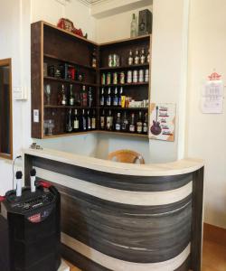a bar in a room with a counter with alcohol bottles at Mangan Stone Pebbles Lodge in Mangan
