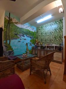 a living room with a large painting on the wall at Mangan Stone Pebbles Lodge in Mangan
