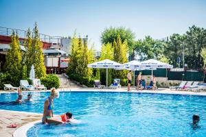 a group of people in a swimming pool at Green Fort Noks Apartments in Sunny Beach