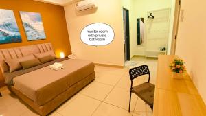 a bedroom with a bed and a table and a chair at Kulai d'putra suites beside ioiMall near Airport and JPO in Kulai