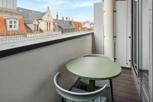 a table and chairs on a balcony with a view at Limehome Zwickau Magazinstr in Zwickau +38 photos