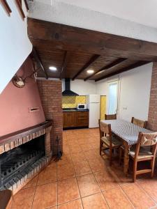 a living room with a table and a fireplace at los hubios in Arroyo Frio