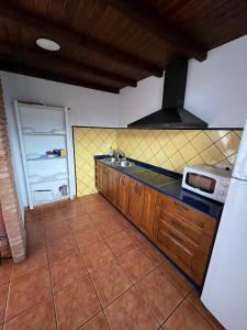 a kitchen with a sink and a stove at los hubios in Arroyo Frio +4 photos