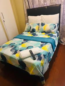 a bed with towels and pillows on top of it at Executive Guesthouse in Vereeniging