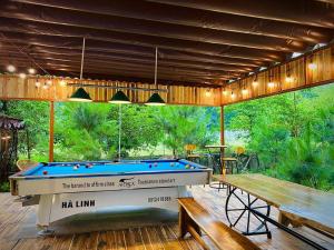 a pool table sitting under a pavilion with a deck at Căn Bali (Moon Villa Sóc Sơn) in Hanoi