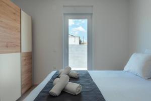 a bedroom with a bed with three towels on it at Luxury Villa Vrsi with Private pool in Vrsi +48 photos