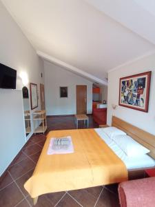 a bedroom with a large bed and a living room at Markovic Apartmani Becici in Becici