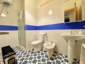 a bathroom with a toilet and a sink at Housingleón Cardiles I y II in León +22 photos