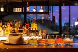 a bar with a group of glasses on a table at Hotel Indigo Tokyo Shibuya in Tokyo