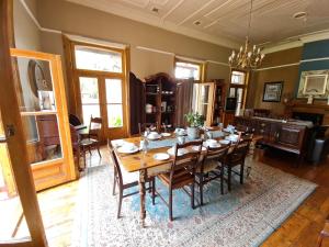a dining room with a wooden table and chairs at Hill Manor Room 1 Self catering unit in Potchefstroom