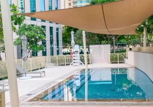 an umbrella over a swimming pool in a building at Superb 1BR at Burj Vista In Downtown Dubai in Dubai