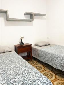 a room with two beds and a table with a lamp at Valencia Well Located Shared Apartment in Valencia