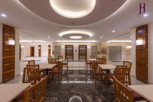 a restaurant with tables and chairs and a ceiling at فندق جوري الهدا مكة in Makkah