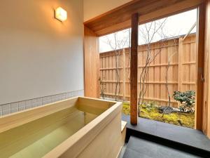 a large tub in a room with a window at NIPPONIA HOTEL 伊賀上野 城下町 in Iga +37 photos
