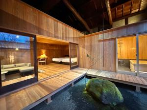 a room with a bed and a pool of water at NIPPONIA HOTEL 伊賀上野 城下町 in Iga