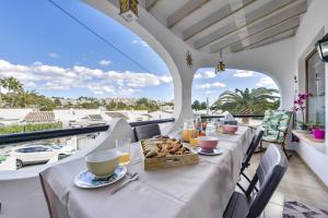 a table with a tray of food on a balcony at Rafol - Casa adosada con piscina comunitaria y tenis comunitario in Calpe