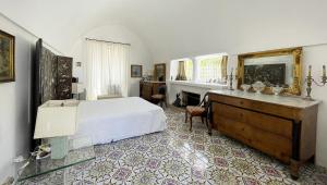 a bedroom with a bed and a dresser in it at Casa Colette in Anacapri